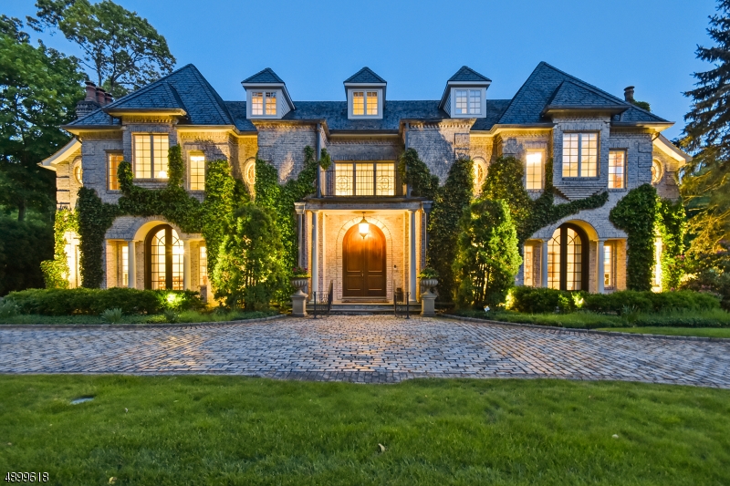 This magnificent all brick French Chateau was custom built to the very highest specifications! The elegantly designed 12,902 sq ft home sits on over an acre & a half of totally level property in an idyllic setting w/a stunning pool & huge blue stone patio. 6 bedrooms, 10 baths & two 1/2 baths w/soaring 12' high ceilings on 1st floor & 10' high ceilings on 2nd floor. Radiant heated floors throughout 1st & 2nd floors, 5 marble fireplaces, 2 kitchenettes &  wet bar, & a stunning mahogany paneled Library. 3-car attached garage with beautiful carriage house above that features a full bath & kitchenette. Incredible amenities including motorized gate on Belgian block driveway, top security system, Nest Thermostats, generator, slate roof, sound system & Brazilian walnut flooring thru out/ limestone bath rooms.