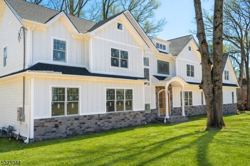 Enjoy the summer on the lake!  Lakefront living in Shadow Lake Estates, distinguished residences with private, membership-only amenities. This custom colonial is a masterpiece, featuring 5 bedrooms, 5.2 bathrooms, and three levels of elegantly crafted living space all set against a breathtaking backdrop. Step through the grand two-story foyer into the first floor, where sophistication meets functionality. The formal living and dining room provide an inviting space for entertaining, while the gourmet chef's kitchen with a center island, custom cabinetry, and a walk-in pantry overlooks serene lake views. A spacious family room with a cozy fireplace, a first-floor guest suite with a private en-suite, and a powder room and mudroom complete this level. The second floor is a retreat of pure indulgence. The luxurious primary suite offers two walk-in closets, a private dressing room, and a spa-inspired bath with a soaking tub, oversized shower, and dual vanities. A private lounge area enhances this serene escape. Three additional bedrooms each feature ensuite baths and walk-in closets, ensuring privacy and comfort for all. The lower level provides even more living space, with a recreation room, media lounge, powder room, and abundant storage. Enjoy members-only access to a premier collection of private amenities, including a clubhouse, pool, boating, fishing, tennis and more.