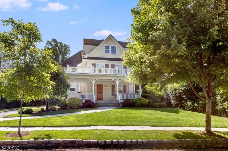 Gracing one of Glen Ridge's most coveted quiet tree-lined streets, this beautifully maintained Victorian seamlessly blends timeless architectural character with thoughtful modern updates. The inviting covered front porch with dense tropical hardwood flooring and a blue bead-board, coffered ceiling creates a memorable first impression and serves as an extension of the home's living space perfect for morning coffee, summer dinners, and gathering with neighbors. Inside, beautiful hardwood floors, coved ceilings, decorative fireplaces and recessed lighting showcase the home's enduring charm. The open-concept kitchen and family room form the heart of the home, featuring stainless steel appliances, double ovens, a five-burner gas cooktop, filtered water, a built-in desk area, and exceptional flow for both everyday living and entertaining. Offering 5 bedrooms, 3 full baths, and 1 powder room, the home also includes updated bathrooms, central air conditioning, a convenient mudroom and a finished walk-out lower-level with recreation room. A two-car garage adds everyday convenience. Ideally located just a few blocks from Glen Ridge's top-rated schools, NYC-direct train service, parks, the town pool, the Women's Club, Fitzgerald's, Starbucks, and the vibrant downtowns of Montclair, this exceptional home offers the charm, community, and commuter-friendly lifestyle that make Glen Ridge one of New Jersey's most sought-after places to call home.