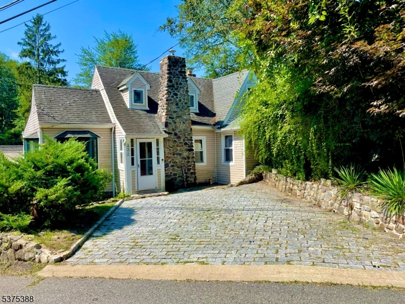 Welcome to this charming 3 bed, 2 bath house in Lake Arrowhead. Enjoy lakefront living with your own private dock space. Enter the front door to a large living room with wall to wall windows facing the lake including an extra den/office space and full bath. The large galley kitchen offers eating space in front of the large bay window and access to an expansive deck for additional outdoor living space. Upstairs features the primary bedroom with abundant closet space, secondary bedroom and main bathroom with large shower stall and skylight. The basement includes washer/dryer, large semi finished space and walkout to the backyard and lake. Conveniently located off of Rt 46 and close to downtown Denville.