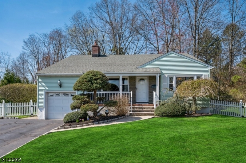 Impeccable home, large back yard, true convenience! nestled on a charming, winding street, this well-maintained Split-Level offers 3 bedrooms, 2 1/2 bathrooms, and an attached one-car garage. A commuter's dream less than ten minutes to the train station, this home is close to schools, parks, downtown shops and eateries, and five minutes to the GS Parkway. With tons to offer both inside and out, this home includes elegantly landscaped front and back yards, a cozy front porch, a stone paver patio, a spacious interior hardwood floors and 2 fireplaces. On the main level, the large living room features a brick fireplace, a picture window, and a vaulted ceiling that enhances the light and airy ambience. Another picture window in the dining room brings in even more natural light. The flow continues to the eat-in kitchen with ample counter and cabinet space and plenty of room for a dinette set. The ground level family room with another wood-burning fireplace spills out to a sprawling patio perfectly situated in the private back yard bordered by trees and shrubs. This level also includes a large laundry room, a powder room, and a mudroom connecting to the attached garage. The upper level includes a primary bedroom with an updated en suite bathroom, two additional bedrooms, and a full bathroom in the hallway. This move-in ready home is set in a beautiful neighborhood convenient to everything and ready to be enjoyed!