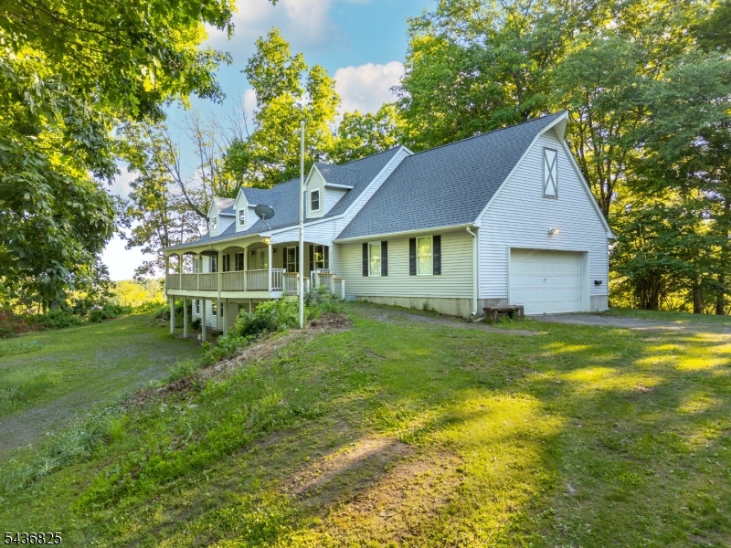 Truly a one-of-a-kind custom-built Colonial nestled on nearly 4 breathtaking acres in the heart of scenic Lebanon Township. Surrounded by nature with stunning views of neighboring farmland & rolling countryside, this private retreat offers the peace and tranquility you've been searching for. Enjoy your morning coffee from the charming covered front porch while taking in the serene setting. Step inside to discover a spacious & inviting layout featuring a large eat-in kitchen, formal dining room, and expansive family room centered around a cozy wood-burning fireplace. Convenient 1st floor primary suite offers a walk-in closet and en-suite bath, providing comfort and flexibility for today's lifestyle. Upstairs you'll find 2 generously sized bedrooms, each with its own walk-in closet, along with a 4th bonus room/partially finished attic space ready for your vision. Whether you need a home office, game room, fitness space, or additional living area, the possibilities are endless. The walk-out basement offers exceptional storage and exciting future finishing potential for even more usable square footage. A house generator is included for peace of mind. Large 2 car garage offers space for parking, storage + workshop potential. Located just minutes from hiking trails, preserved open space, the scenic Musconetcong Valley, & the natural beauty that makes Lebanon Twp. so desirable, this exceptional property combines privacy, space, and endless potential in a truly picturesque setting.
