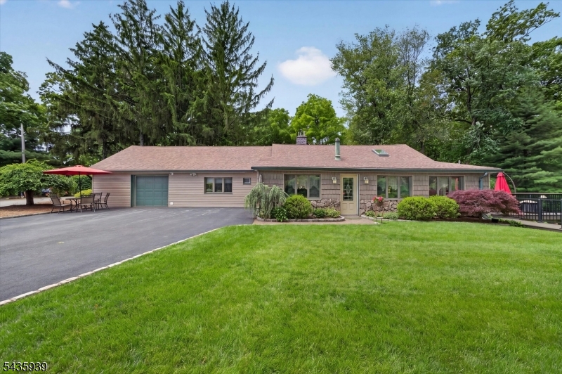 Spacious home offering over 2,100 square feet of living space, ideally situated across from the lake. This property presents excellent potential for expansion and customization to suit your needs. Features include natural gas service, central air conditioning, an underground sprinkler system, a new Trex deck, and a whole-house generator for added peace of mind. The home is also equipped with a 1,000-gallon septic tank. Enjoy a desirable location, ample living space, and endless possibilities to make this property your own.