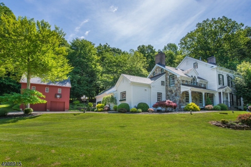 Circa 1807 replica of famous S. Orange antique home, this beautiful colonial offers total wooded privacy, stream, paver walkways w/professional landscape & detached 2+ car bank barn w/full loft above. Custom home features solid wood interior doors, built-in glass front cabinets, hardwood flooring on all 3 levels, incl a walk-up 3rd story w/ bonus room, closets & bath.  Huge custom kitchen w/ granite counter tops & commercial appliances, large first floor office outfitted w/ custom cabinetry, 4 fireplaces, breakfast nook, in addition to the eat-in kitchen and formal dining room, 200+ square foot mbr closet, finished basement, attached 2 car garage, 1s floor laundry and so much character!  Must be seen to be fully appreciated!  Chester schools & West Morris Mendham HS.  5 min to Gladstone NJ Transit station.