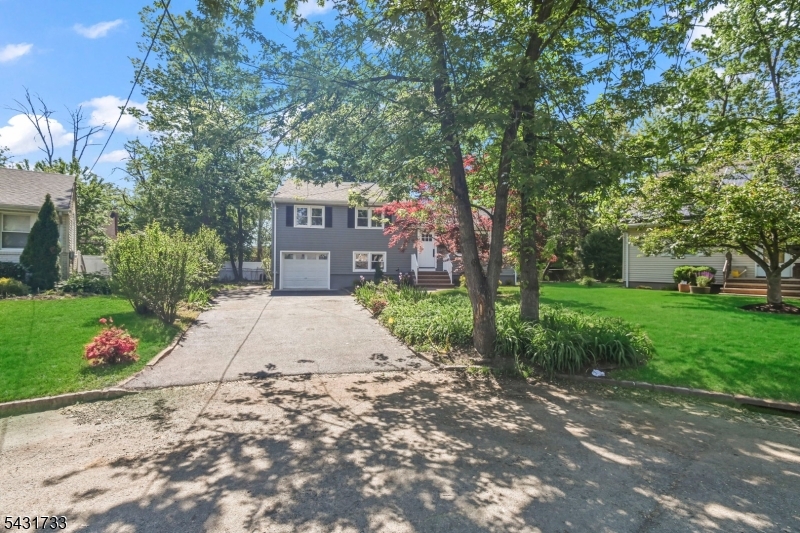 Stunningly remodeled 3 bedroom, 2 full bath split-level home in highly sought after Scotch Plains! This beautifully updated residence showcases gleaming hardwood flooring throughout and an open, inviting floor plan designed for both everyday living and entertaining. The formal living room flows seamlessly into a spectacular designer gourmet center island kitchen featuring custom white Shaker cabinetry, quartz countertops, subway tile backsplash, stainless steel appliances, and abundant workspace, making it ideal for holiday gatherings and hosting guests. Step down to the spacious 18x12 family room conveniently located adjacent to a full bath, offering the perfect space for relaxation or entertaining. The upper level features three generously sized bedrooms, all with gleaming hardwood flooring. The primary bedroom offers direct access to a stunning European-style full bath that also provides hall access for added convenience. Enjoy the fully enclosed patio overlooking the large, level fenced backyard, perfect for outdoor enjoyment, play, or future entertaining possibilities. Additional features include a one-car garage, new roof, new HVAC system, and exceptional updates throughout. Pride of ownership and attention to detail are evident in every room of this truly move-in ready home. Must be seen to be appreciated!