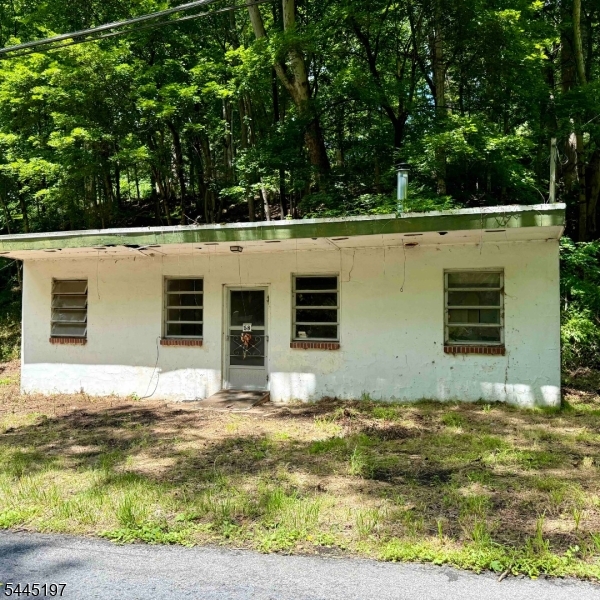Opportunity to build a custom home with much of the pre-development work already completed, including DEP permits, survey, septic design, architectural plans, and an existing foundation. Build Your Dream Home in Lebanon Township. An excellent opportunity to create a custom home in a beautiful Lebanon Township setting. The property includes an existing foundation and architectural plans for a three-story residence with approximately 2,220 finished interior living area, plus an oversized two-car garage. The proposed layout includes a ground level with a foyer, garage, and utility room; a second level with an open-concept kitchen, dining, and living area, full bath, office, and wraparound deck; and a third level with two bedrooms, two full baths, generous closet space, and a primary suite.The seller has obtained DEP Flood Hazard Area permits and verification, completed a property survey, finalized the septic design, and assembled a full set of architectural plans, helping simplify the path toward construction. The buyer will be responsible for obtaining building permits.The lot features a scenic creek, offering privacy, natural surroundings, and convenient access to the area. The existing structure is not habitable and will require substantial renovation, an addition, or new construction before a Certificate of Occupancy can be obtained. Property is being sold strictly as-is.