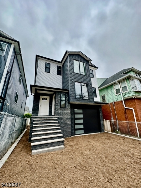 Welcome to this new construction two-family home, currently being built according to plans, offering the ideal combination of style, space, and convenience. This home is larger than the typical new two-family builds, featuring a well-designed layout with exceptional space throughout. The first floor is connected to the ground level, offering a total of 4 bedrooms, 3 full bathrooms and a finished recreation room, creating an ideal setup for extended living or flexible use. The second-floor features 3 bedrooms and 2 full bathrooms, providing a comfortable and modern living space. Enjoy a bright, open-concept layout with central air and forced hot air heating for year-round comfort. Elegant hardwood and ceramic tile flooring add a touch of sophistication, while walk-in closets provide generous storage. Each unit includes a well-appointed kitchen with ample cabinetry and counter space, ideal for everyday cooking and entertaining. A two-car garage with an automatic opener ensures added ease and security. Step outside to a spacious backyard, perfect for summertime gatherings and outdoor enjoyment. Located in a highly desirable area with easy access to major highways, schools, Jersey Gardens Mall, Newark Airport, hospitals, and NJ Transit. Additional perks include a 5-year tax abatement and a 10-year homebuyers warranty, a rare find! Don't miss out, schedule your private tour today! Home qualifies for the CRA Program, as little as 5% down, no PMI, and a low interest rate.