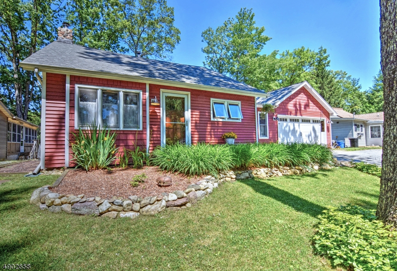 Come enjoy life at the lake in this charming 2 bedroom, 2 full bathroom waterfront property. Stroll down to your personal dock in the crisp morning air where a vista of  mountain scenery awaits. The main floor has 1 bedroom with eco-friendly cork flooring, 2 full baths, combo dining/living room, and galley kitchen. Upstairs is a spacious bedroom. Play at your own water frontage, enjoy the perks of Lake Swannanon with their well maintained lake/playground area or just relax in front of the wood burning fireplace. The 50" television is included with the property to help make this the perfect secret getaway. W/D also included. Tankless water heater provides a space saving and cost efficient solution for hot water in this perfect lakeside home. Convenient to schools, major shopping and commuting.