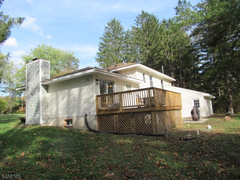 Beautifully updated home situated on nearly 2 private acres in desirable Washington Township. Privately set on a quiet road bordering the scenic Musconetcong River, this property offers a rare combination of peaceful natural surroundings and modern improvements. Recent updates include a new roof, siding, stone veneer front exterior, upgraded chimney, deck, doors, and windows. Interior improvements feature engineered wood flooring, fresh paint, recessed lighting, new insulation, and a spacious recreation room perfect for entertaining or relaxing. Additional upgrades include newer plumbing, electrical, and water systems, an added bathroom, and two oversized walk-in closets. The home also offers 3 attic spaces providing excellent storage potential. A brand-new septic system was installed in 2021. Whether used as a peaceful weekend retreat or a full-time residence surrounded by nature, this home offers comfort, privacy, and endless potential. Front porch and landscaping remain ready for the future owner's personal vision and finishing touches.
