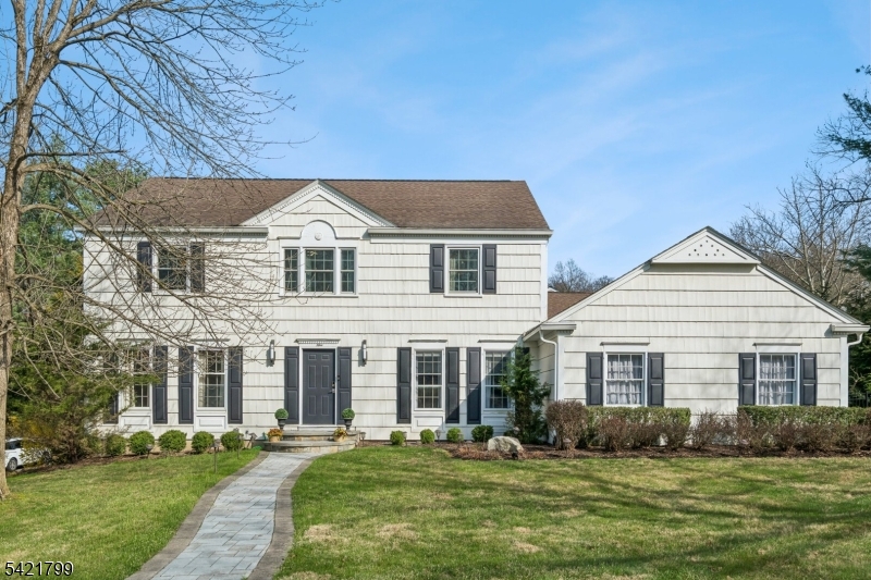 Beautifully updated 4-bedroom, 2.1-bath center hall colonial set on a fenced corner lot in desirable Olde Wheatsheaf Farms. From the moment you enter, sightlines draw you straight through to the sunlit, renovated kitchen, an all-white, contemporary space with a large center island and a 6-burner Bertazzoni Italian range with double ovens and griddle, JennAir refrigerator, perfect for everyday living and entertaining. The adjoining family room features a classic brick fireplace and sliders that open to a private patio and backyard, creating an easy indoor-outdoor flow. A well-appointed laundry room just off the kitchen includes a custom dog bath, an exceptional and thoughtful touch for pet owners. Light-filled and inviting throughout, the home offers generously sized rooms, a walk-up attic with skylight, and newer windows in many areas. Move-in ready with a seamless blend of comfort, style, and functionality in one of the area's most sought-after neighborhoods.