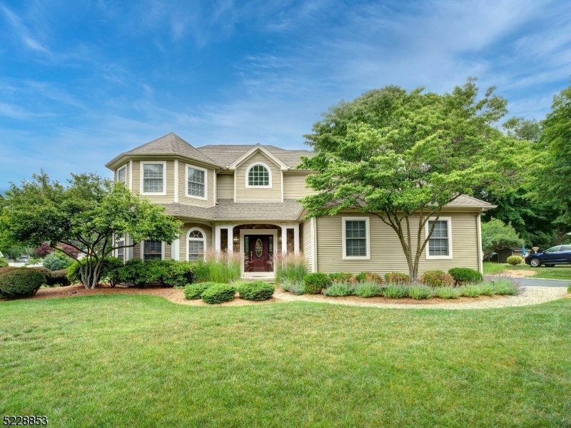 PRIDE OF OWNERSHIP abounds here at this meticulously maintained colonial featuring impeccable finishes throughout. Beautiful wood floors, gorgeous stone fireplace, decorative moldings, iron baluster staircase & monochromatic palette. This beauty is located on a professionally landscaped corner lot on a cul-de-sac street. Expect to be impressed as you enter into the 2 story foyer w large palladium window. Open floor plan & very spacious rooms. Dream kitchen has newer stainless steel appliances inc double oven, plentiful cabinetry & counter space inc large center island & separate dining area that leads to paver patio/yard. Adjacent to kitchen is the great rm w trey ceiling & stone fireplace. Formal living & dining rooms are entertainers delight. The perfect primary bdrm features trey ceiling, 2 walk-in closets & ensuite w soaking tub, dual sinks & glass enclosed shower. 3 add'l large bdrms, incl one room w BONUS sitting room/playroom complete the 2nd floor. FINISHED GARAGE is ONE OF A KIND w crown molding, epoxy flooring & built-in cabinetry. Also included is full CAR LIFT to fit a 3rd car. Mudroom & laundry rm off garage for convenience. Full Finished & spacious basement has a built-in entertainment armoire, home office area & plenty of storage. SPECIAL FEATURES INCLUDE whole house sound system (receiver is negotiable), recessed lighting, Underground irrigation system, WHOLE HOUSE GENERATOR & PUBLIC UTILITIES! Location great for commuters. Mins to park, school, stores etc.
