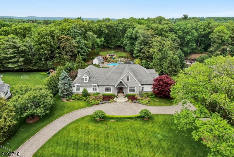 Something amazing happens when high quality construction and design are in harmony. It hits the perfect balance. Suddenly, the spaces inside have attitude...a voice. As you enter this exceptional estate, breathtaking architectural details blend to perfection with an open concept flow and modern-day spaces, fixtures, and detail. Find a huge light filled great room opening to a designer kitchen with 2 huge islands and the highest end appliances including a custom La Cornue range. Over the last 2 years, this house has undergone a complete $1.1MM renovation creating a unique bonus flex space, adaptable rooms, a spectacular Lower Level speak easy lounge/pub(with wet bar), music room plus media, gym, full bath. There is so much more...a LUXE Primary Suite (with a WOW! Walk-In-Closet that must be seen), 2 additional bedrooms and office on the main level. NEW 2000 sf 2nd floor guest suite with 2 bedrooms, family room, kitchenette, and spa bath! Sitting on 1.5 pristine acres of perfection! One of Franklin Lakes premier locations!