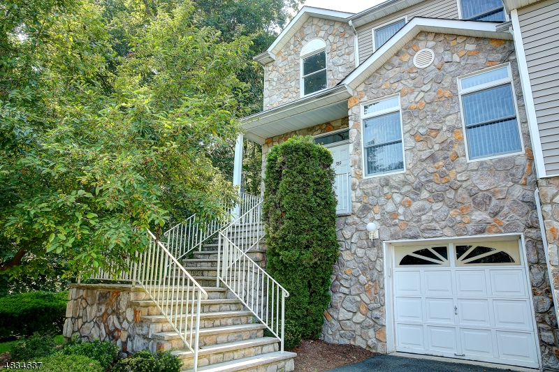 Builders own unit, lots of upgrades, custom hard wood flooring, carpeting in Bedrooms, open floor plan, finished basement, freshly painted and cleaned. Large deck and backed by woods. Kitchen bright and airy. Fireplace Crown Molding beautiful finishes!!!! Living room with sliding glass doors to deck plus recessed lighting.  Kitchen open to to LR and Dr.  End unit situated on a cul de sac.$50 extra for pet