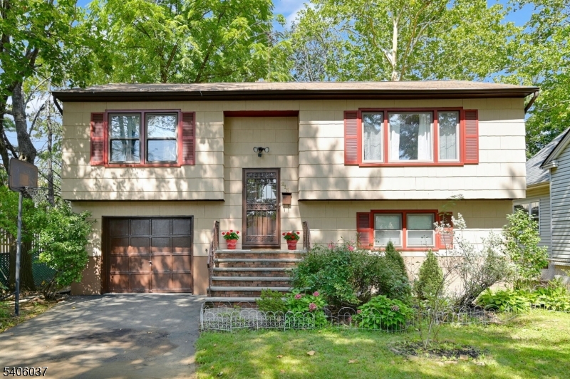 This move-in-ready expanded bi-level home offers 4 bedrooms, 2.5 baths,& approximately 2,646 sq ft of living space, ideally located in a high-demand Blue Ribbon school district. From the moment you enter, you're welcomed into the living area by a warm, inviting layout filled w/ natural light. Recent updates include a newer furnace & A/C (2022), Wi-Fi"enabled refrigerator (2022), dishwasher (2023) & exterior freshly painted in 2022. The main level features a spacious living room, formal dining area & a kitchen w/ newer stainless-steel appliances. The primary bedroom features a cathedral ceiling, skylight, four full-size windows, recessed lighting, and ample closet space. The primary bath includes a jacuzzi tub, stall shower, and recessed lighting. 2 additional bedrooms & an updated full bath complete this level. The lower level offers a family room w/ a fireplace & large open recreation area. A fourth bedroom, half bath, heated mudroom & laundry room provide flexible living space. Enjoy outdoor living on the newly painted deck overlooking a large backyard, perfect for entertaining and gatherings. Additional features include a 1-car attached garage. Conveniently located near top-rated schools, shopping, restaurants, parks, major highways & NYC transportation. A wonderful opportunity to own a move-in-ready home offering comfort, space & convenience. NOTE: This listing includes both current photos of the home & AI-enhanced images to help visualize possible potential updates.