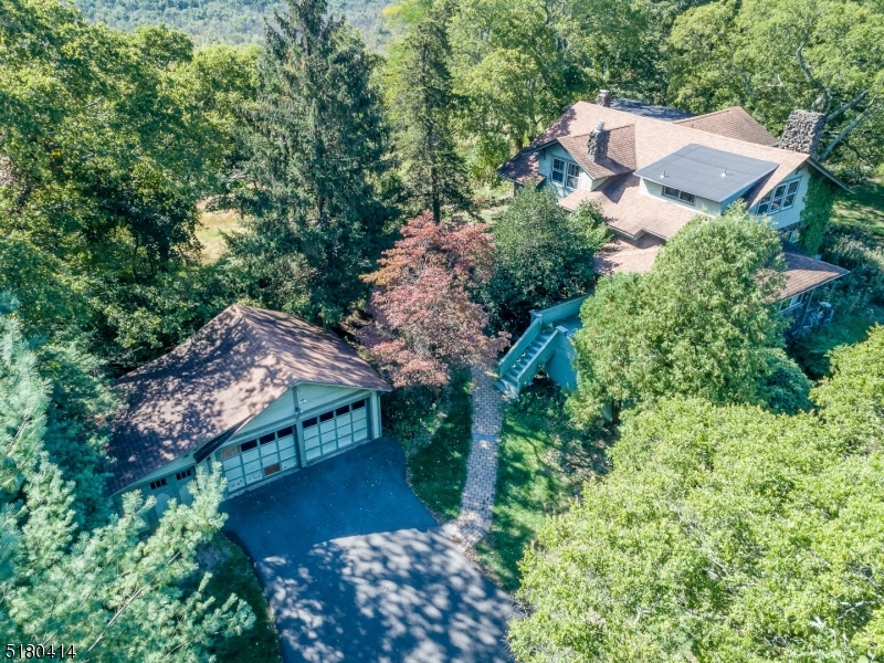 Opportunity Knocks: Custom Craftman style home on over 8 Acres with the possibility of sub division. Builders and investors renovate the home and build additional homes. Or looking for a retreat yet an easy commute to NYC by car, bus or train. Enjoy the vistas to the South overlooking the Great Piece Meadows Preserve and to the North the Ramapo Mountains. This spacious home has loads of charm. You will love the 3 season rm with stone walls and large windows. Exit here to the deck to enjoy the outdoors. Loads of natural light flows into each room. Character abounds throughout with a fireplace in the living room room and family room. Entertain in the large living room, adjacent to the dining room. The galley kitchen has a breakfast room. On the second level you will find 4 good size bedrooms. The primary bedroom has a full bath, 2 bedrooms have sink closets, and one has a sink and a commode. All have spacious closets. Wood floors and whole house generator.