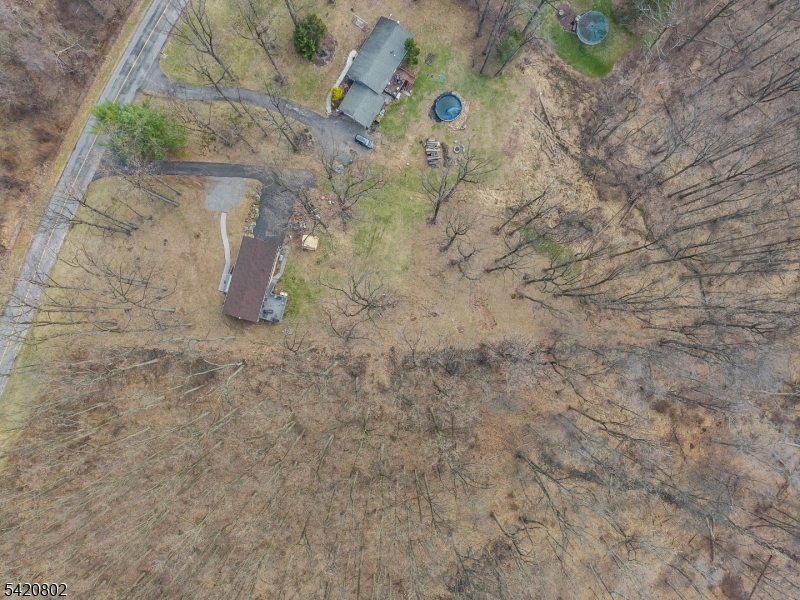 Welcome home to this pristine raised ranch nestled in a serene, wooded setting offering privacy and peaceful country living at its best. A spacious deck off the kitchen overlooks the backyard and a large, wooded parcel perfect for enjoying nature year-round. The kitchen was beautifully updated in 2014, with new appliances added in 2018.  Three generous size bedrooms with the primary bedroom having its own half bath. This meticulously maintained home offers a dry basement with direct access to a two-car garage and has been cared for top-to-bottom.Major improvements include a septic tank and distribution box upgrade in 2006, with additional septic repairs completed in 2023. The underground oil tank was removed at the time of the seller's purchase and an above-ground tank installed. Additional updates include a one-year-old roof, new split system, updated plumbing piping, a new chimney liner (2022), and a new well pump (2020). Truly move-in ready, this home is ideally located right off Route 78, making commuting easy, and is convenient to Clinton and Phillipsburg for shopping and dining.