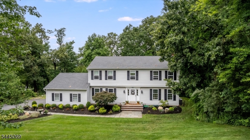 Nestled in the highly sought-after Trail Wood neighborhood of Hanover Township renowned for its low taxes & exceptional schools. This classic center hall Colonial offers 4 bedrooms & 3  baths. The first floor features a warm & welcoming FR with a fireplace, along with formal living & dining rooms. The spacious eat-in kitchen includes a center island with sink, abundant cabinetry & counter space, & a pantry, plus a convenient mudroom off the kitchen that provides access to the oversized two-car garage.  Sliding glass doors from the family room open to an impressive 24' x 16' screened-in porch & a wraparound deck, creating a wonderful indoor-outdoor living experience.Upstairs, the primary suite offers a full bathroom &  walk-in closet. Three additional bedrooms are generously sized with ample closet space, and a full hall bath completes the second level. The fully finished basement provides even more living space with new flooring, a recreation room, an updated bathroom with a spacious shower, a laundry room, and an office. Outside, the lower level of the backyard is perfect for gatherings, featuring a paver patio with built-in seating and a 30" Breeo Smokeless Fire Pit. Additional highlights include an oversized two-car garage equipped with a Tesla Wall Charger. Residents of amenity-rich Hanover Township enjoy access to the community center, before & after-school programs. Convenient access to the Morris Plains Train station with Midtown Direct service to NYC.