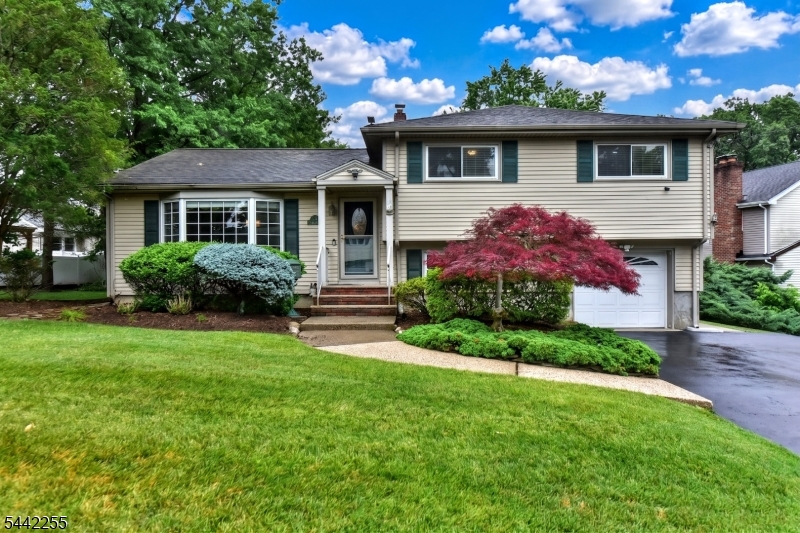 Welcome home to this beautifully maintained, sun-drenched 3-bedroom, 2.5-bathroom split-level residence located in the heart of desirable New Milford.  As you step inside the welcoming entry, the main level invites you into a spacious, bright living room that flows naturally into a formal dining room ideal for hosting gatherings. The adjacent eat-in kitchen features ample cabinet space and easy access to the living areas. Upstairs, the private quarters include a serene primary bedroom complete with its own dedicated en-suite bathroom, along with two additional generously sized bedrooms and a full hallway bath.  The ground level features an expansive, versatile family room or den with convenient access to a modern powder room, the attached garage, and sliding glass doors that lead out to a private patio and an oversized backyard. An additional finished lower basement level provides excellent bonus square footage, perfect for a home office, recreation room, or extra storage. Complete with central air conditioning and beautiful hardwood floors, this home is situated just moments away from  beautiful local parks, premium shopping, and effortless New York City transit.