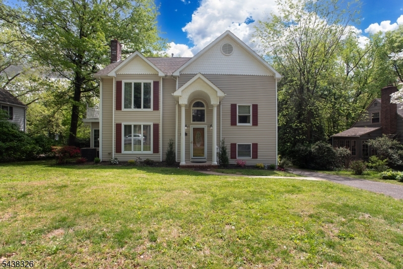 Nestled in one of Westfield's most desirable neighborhoods, this exceptional custom Colonial blends timeless elegance with modern comfort. Just one block from Washington School and less than a mile from downtown Westfield and NJ Transit, the location is hard to beat. The main level features a formal living room with a gas fireplace, an elegant dining room, and a chef-inspired kitchen with premium stainless steel appliances, under-cabinet lighting, and an expansive breakfast bar. Anderson windows and doors throughout provide abundant natural light and energy efficiency. French doors open to a wraparound Trex deck overlooking a private, park-like backyard perfect for entertaining or relaxing. The upper levels offer spacious bedrooms and a luxurious primary suite featuring a gas fireplace, walk-in closet, jetted tub, steam shower, and a bright skylit loft ideal for a home office, sitting area, or potential fifth bedroom. The walk-out basement offers outstanding flexibility with high ceilings, a full bath, second laundry area, and two private entrances ready to be finished as a recreation room, gym, guest suite, or work-from-home space. Additional highlights include 3-zone heating and cooling, 200-amp electric service, built-in speakers, ample storage, and a one-car garage. Don't miss out on this rare opportunity to enjoy exceptional space, comfort, and convenience in the heart of Westfield.
