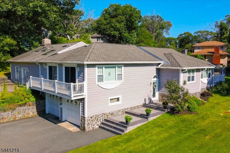 Welcome to this Custom 3 bedroom, 2 bathroom Expanded ranch in the sought-after Lake Hopatcong section of Jefferson Township, where thoughtful Design and Abundant Natural Light create a warm, inviting atmosphere. The open floor plan is enhanced by soaring Cathedral Ceilings, Skylights, and Elegant French Doors throughout the home. At the heart of the home is a spectacular Great Room featuring a floor-to-ceiling real stone Rumford fireplace with a raised Bluestone Hearth, creating a stunning focal point. The Heated floors extend throughout the Great Room and into one of the bedrooms, adding comfort and warmth during the colder months! The spacious kitchen offers Granite countertops, a Center Island with Double Sink, Stainless Steel appliances and more Skylights! The expansive Primary Suite is a true retreat, complete with two sets of French doors leading to a large Trex-style deck and a beautifully appointed Ensuite Bathroom featuring a custom Roman shower and Stone vessel sink. A Jetted Soaking tub in the guest bathroom, convenient First-floor Laundry, and a Fully Fenced Backyard add to the home's appeal. Outdoor living is equally impressive, with an expansive Deck, two Paver Patios, and ample space for Outdoor Entertaining, Dining, or simply Relaxing. Offering exceptional character, flexible living space, and quality craftsmanship, this one-of-a-kind home is just minutes from Lake Hopatcong's Marinas, Restaurants and year-round Activities. Interior Pics to come.