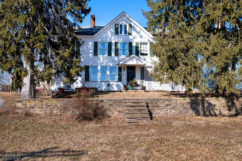 For more than a century, this 193+acre dairy farm in Sergeantsville has been a pillar of hard work, tradition, and resilience. With 3 separate lots: Lot 0006/Blk 00053 comprises 99.60 acres / Lot 00005 / Blk 00053 comprising 92.51 acres (combined these are farm assessed for a total of $2,446/year) and the 3rd is lot 0005/Blk 00053 1.82 acres where the house stands and taxes are $14,105/year. 10+ acres being added under Township resolution. This Century old farm has all the infrastructure needed to reclaim its past as a thriving dairy operation. Anchoring the property are three towering silos and a classic dairy barn, complete with a milkhouse and a hay loft capable of storing up to 12,000 bales of hay. Newer fencing around cattle yard. A machine's barn, a pole barn, a four-bay tractor garage, and a well-insulated produce shed provide ample space for equipment, feed, and storage. Dedicated feedlot and an additional barn, ensuring that every aspect of a working dairy is already in place. The antique farmhouse features original doors, fixtures, and wide pumpkin pine floors. Currently configured as a 3-bedroom home with additional rooms used for storage, a full restoration could recreate the four +-bedroom house. Newer 200 AMP service. Bucolic and picturesque -  with sweeping vistas of the Delaware Valley and gently sloping pastures. With a diversity of crops, or agricultural enterprise, this property offers everything needed for a new chapter of farming success.