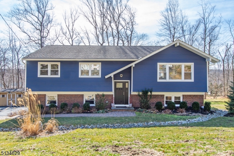 No more showings! Bright, Sunny, and fully Updated Bi-Level home in the heart of Shongum Lake! Walk in to a wide open foyer, that leads you up to an open concept Kitchen/Dining/Living room on the main level, creating an ideal space for entertaining. Walk out from the kitchen to a spacious NEW composite deck, overlooking seasonal fall/winter views of Shongum Lake. Updated Kitchen features white cabinetry, granite countertops, SS appliances & island. Updated baths offer a spa like feel with stone tiles. Hardwood Floors throughout main level. The lower level has a cozy family room with wood burning fireplace and walkout to a patio, a 4th bedroom currently being used as an office. Absolutely nothing left to do but move in to this Gorgeous Home! Enjoy Shongum Lake and all it's amenities and social events year round!