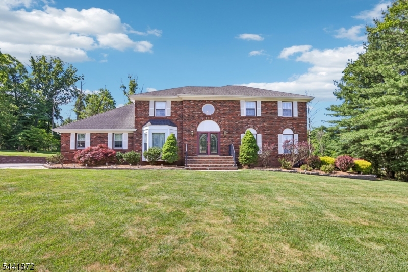 Located on a private cul-de-sac in one of Randolph's most desirable neighborhoods, 4 Viking Ct offers a rare opportunity to own a stately brick-front colonial with exceptional curb appeal and a rare 3-car garage. A dramatic two-story foyer welcomes you into spacious living areas designed for both everyday living and entertaining.The kitchen opens seamlessly to the family room featuring a wood-burning fireplace, creating the heart of the home. A large formal living room and formal dining room provide elegant gathering spaces, while a powder room completes the main level. Replaced windows throughout enhance natural light and efficiency. Upstairs, four generously sized bedrooms include an expansive primary suite with a walk-in closet, sitting room, and large ensuite bath. A hall bathroom with double sinks and a tub serves the additional bedrooms.The finished basement adds tremendous flexibility with a full bathroom and kitchenette, making it ideal for recreation or guests. Enjoy outdoor living on the large deck overlooking a beautiful park-like yard. Additional highlights include public water, sewer, and natural gas utilities. Located within Randolph's top-rated school district and convenient to major highways, Morristown, Newark Liberty International Airport, and NYC commuting options, this home offers the space, versatility, and location today's buyers seek.