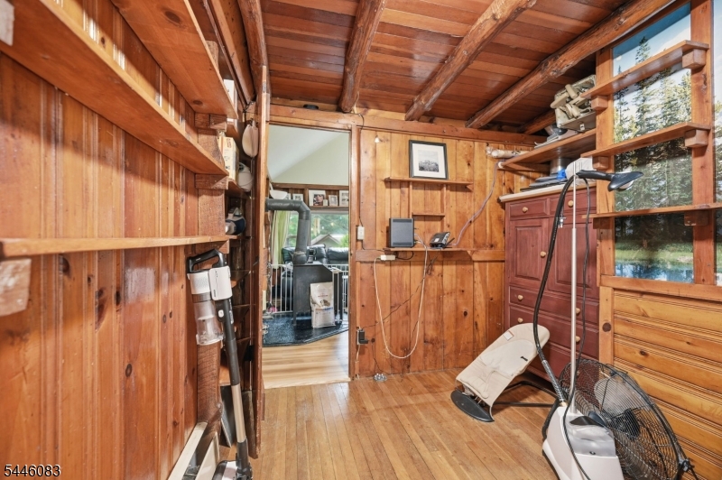 Welcome to this charming and rustic Log/Ranch home nestled in the desirable Greenwood Lake's Lakeside community. This unique home features a bright and airy open floor plan highlighted by cathedral ceilings, skylight, and a cozy freestanding wood stove in the living room. The main level offers convenient living with a primary bedroom, an additional bedroom, a full bath, and a functional galley kitchen that flows into the living/dining combo. Upstairs, a spacious loft area serves perfectly as bedroom, home office, or Den. Positioned on a quiet cul-de-sac and backing directly to protected state parkland, this property offers ultimate privacy and seclusion. Enjoy a built-in garage, and an ideal location close to shopping, dining, transportation, and year-round outdoor sports. The optional $500 membership per year fee entitles you use of the clubhouse, events, and beach. NYC commuter bus very nearby and awesome eateries, wineries, and micro breweries.