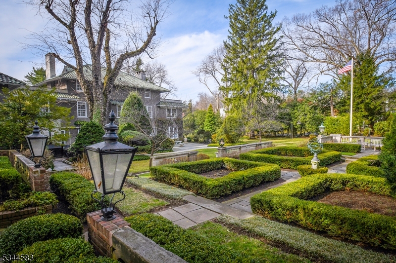 Constructed in 1914 in the heart of Old Short Hills, this unique 7-bedroom 5.1 bath stucco-cladItalian Renaissance-style home captures the distinctive architectural style of its era. Poised on.84 acre of exquisitely curated English gardens, the home boasts a center-hall floor plan with grand-scale rooms anchored on rich ribbon-banded herringbone floors, with 9' high ceilings,elaborate trims, oversized windows and wide entries that lend elegance and sophistication.A charming, fully outfitted one-bedroom carriage house apartment sits above a three-car garage fronted with three sets of vintage swinging glass-paned doors.  Ideally located near Glenwood Elementary, access to ranked Millburn Middle School and  Millburn High School, a mile from Short Hills NYC Midtown Direct train and Gero Park.  This stately home is a showcase property in Short HillS, truly one of its kind!