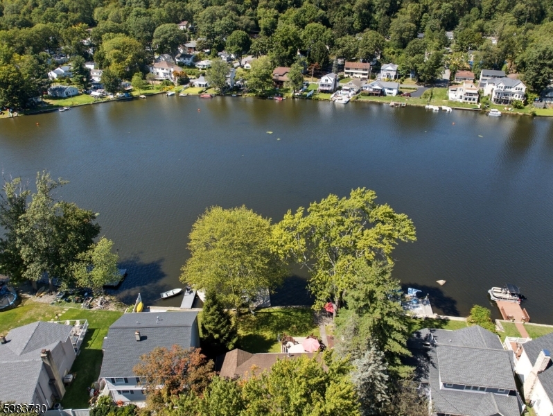 Welcome to your dream LAKEFRONT RANCH in Indian Lake. Rare 1 floor living w/potential. Spacious footprint on a lot & a half leveled property, breathtaking views & inviting backyard. Abundance of back windows radiates natural light, creating a warm & inviting interior ambiance. Charming Front Porch takes you into the updated kitchen w/SS appliances, quality cabinetry, breakfast bar & skylight. This is the heart of the home, open to all living spaces. Meals can be passed through to the Grand Dining Room. Whether relaxing in the Living or Family Room, you can soak up lake & seasonal views. Family Room features corner gas fireplace enhancing the rooms warmth & sliders to the back deck. 3 bedrooms with largest one offering pretty Lake views. One BDRM used as an office w/Murphy Bed which will be sold with the home. Updated 2 sink main bath, powder room, laundry/mud room & garage used as storage & shed space currently. Could be easily converted back. The serene & picturesque backyard is a winner. Beautiful deck, patio & dock will make any lake lover want to move right in. Well maintained home, lots of TLC! Boating, Fishing, Swimming & Ice-Skating are just a few of the fun activities this property has to offer w/many housed at the active & vibrant community club like the 4th of July boat show & FUN weekend. This is the lifestyle anyone would want. Mins to DWTN Denville to explore shopping, restaurants & events. A commuters delight w/hwys, train & bus direct in NYC. TOP schools.