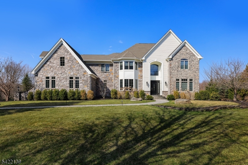 Welcome to this exceptional residence nestled on a breathtaking, park-like property that offers both privacy and serenity.  This beautifully maintained home combines elegance, comfort, and functionality in every detail.  Step inside to discover a thoughtfully designed layout featuring a spacious living room, formal dining room, and a private office-perfect for today's flexible lifestyle.  The inviting family room is a true showstopper, highlighted by a stunning coffered ceiling and warm, welcoming ambiance.  At the heart of the home is a gourmet kitchen, ideal for both everyday living and entertaining, complemented by a sun-drenched sunroom that brings the outdoors in and offers picturesque views year round. The fully finished basement expands your living space with incredible versatility, featuring a dedicated exercise room, full bathroom, multiple entertainment area, and a full bar-perfect for hosting gatherings or relaxing at home.  Additional highlights include a whole-house generator for peace of mind and beautifully landscaped grounds that create your own private retreat.  This is a rare opportunity to own a home that truly has it all-luxury, space, and an unbeatable setting.