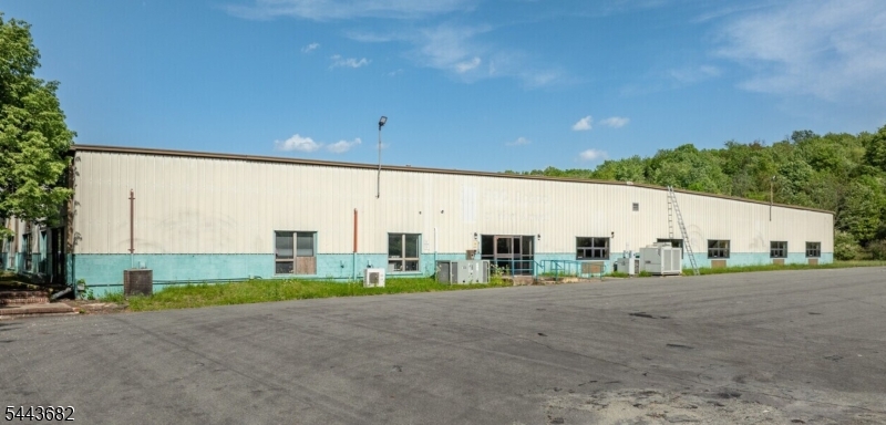 An exceptional opportunity to acquire a highly versatile industrial/flex facility in the heart of Hunterdon County. Situated on approximately 15 acres with outstanding frontage along Route 179, this free-standing  64,200-square-foot building offers the flexibility to accommodate manufacturing, warehousing, distribution, logistics, contractors, showroom, office, research and development, fitness, and a wide variety of commercial uses.Originally constructed in 1979, the property features expansive clear-span warehouse areas with ceiling heights reaching approximately 28 feet, complemented by additional flex and office areas that can be configured to meet the needs of a single owner-user or multiple tenants. The flexible floor plan provides excellent opportunities for owner occupancy, investment, or multi-tenant leasing.Designed for efficient industrial operations, the facility includes multiple loading options with dock-high loading doors and drive-in doors, heavy 3-phase electrical service, sprinkler system, gas heat, central air in office areas, and generous truck circulation. The expansive paved parking area accommodates approximately 60 vehicles while also offering potential outdoor storage or contractor yard space, subject to local approvals.