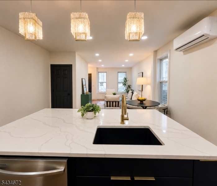 Welcome to 22 Union Street, a stunning gut-renovated single-family home with a bonus unit in the heart of Bergen-Lafayette, one of Jersey City's fastest-growing neighborhoods. This bright and airy residence blends timeless charm with modern luxury, featuring brand-new hardwood floors, an open-concept living and dining area, and a beautifully designed chef's kitchen centered around a striking oversized island perfect for entertaining. Natural light pours throughout the home, creating a warm and inviting atmosphere across every level. Offering 2 spacious bedrooms, a flexible den/home office, and 4 bathrooms, this thoughtfully designed layout delivers both comfort and versatility. The finished basement with private entryway adds incredible bonus living space ideal for guests, recreation, a studio, or extended living. Enjoy seamless backyard access perfect for summer gatherings, gardening, or quiet outdoor relaxation. Washer and dryer conveniently located on the main living floor. Located moments from Berry Lane Park, trendy cafes, local restaurants, and the Hudson-Bergen Light Rail, this home offers the perfect balance of neighborhood charm and commuter convenience with quick access to Downtown Jersey City and NYC. A rare opportunity to own a turnkey Bergen-Lafayette gem surrounded by growth, culture, green space, and vibrant city energy.