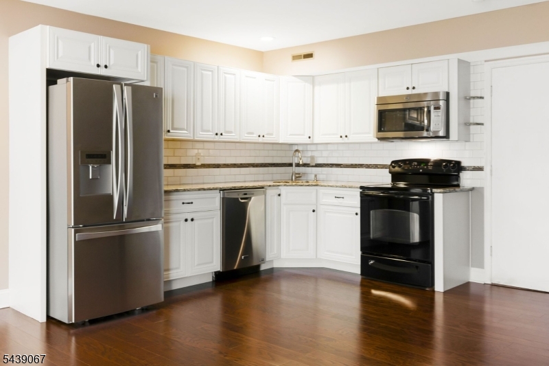 This beautiful home with an open floor plan offers the ideal combination of features you've been searching for: 2 bedrooms, 1 full bath, a half bath, updated kitchen, a large primary bedroom, 1 attached car garage and located in Scotch Plains with close proximity to downtown Scotch Plains and downtown Westfield. Showcasing an updated kitchen with granite countertops, modern finishes and appliances, this unit is filled with abundant afternoon natural light, offering warm, inviting living spaces and a comfortable layout. Hardwood floors throughout. Step outside to a private, peaceful and lush backyard that is perfect for an outdoor quiet enjoyment or outdoor dining. Conveniently located near the Westfield Train Station, providing an easy commute to New York City. Close to shopping, dining, parks, and major transportation routes, making this home an ideal blend of suburban comfort and convenience.