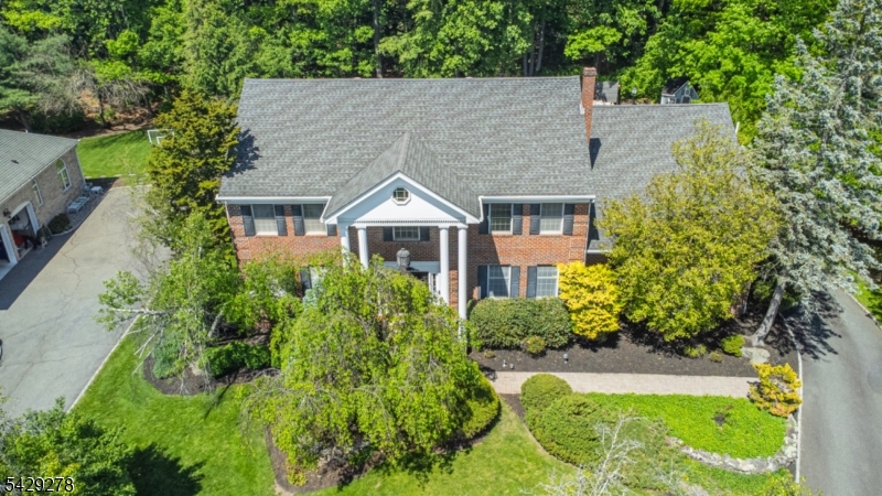 Exceptional VALUE on STUNNING 5BR, 4.2BTH CHC located on one of North Caldwell's most desirable streets! Step inside the grand entry foyer featuring elegant marble flooring with custom mosaic design. Spacious LR with gleaming hardwood floors, double French doors. Impressive Great Room with soaring vaulted ceilings and cozy FP. The gourmet EIK is a chef's delight with marble counter tops, S/S appliances, center island and easy tiled flooring. 1st Floor has an ensuite BR that doubles perfectly as a home office or in-law suite, plus a spacious laundry room with stylish barn doors for privacy. The primary suite has two walk-in closets, hardwood floors, a spa-like bath featuring a double-sink vanity, deep soaking tub, and separate stall shower. The additional bedrooms are generously sized with large closets throughout the home (including a total of 4 walk in closets), offering incredible storage. Two bedrooms share a convenient Jack & Jill bath with dual sinks and oversized shower, while the main second floor bath features another double sink vanity. The large finished basement is an entertainer's haven" complete with a new half bath, durable LPV flooring, and custom built in cabinetry.  Additionally, there is a separate exercise area and a cozy hidden nook. Beautifully landscaped yard with a charming cottage dollhouse. Conveniently located near NYC transportation, schools, shopping and major highways!