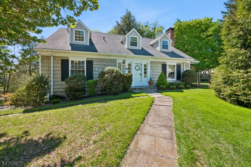 This exceptional 4-bedroom, 3.5-bath home offers a rare blend of timeless craftsmanship, thoughtful upgrades, and enduring quality. Originally built by renowned Short Hills builder George Lauber as his personal residence, the home has been meticulously maintained and thoughtfully improved over the years. The beautifully appointed kitchen, features semi-custom, inset cabinetry, leathered granite countertops, and a full suite of high-end stainless steel appliances. Hand-blown Juliska pendant lighting and designer finishes add warmth and sophistication. The first floor bathrooms are equally refined with Italian marble countertops and premium Hansgrohe fixtures. Throughout the home, quality and detail are evident, from the Pella windows with individual wood mullions (all windows have been replaced) to the beautiful oak floors throughout. A spacious first-floor laundry room adds convenience, while the finished basement - with direct access to the over-sized garage - offers a playroom/recreation space. The unfinished attic space on the 2nd floor is already outfitted with gas and electric, which provides potential for future expansion. Set on a flat, private, fenced property, the outdoor space is equally inviting, featuring classic cedar shake siding (stained for durability), a Kwanza cherry tree (blooms each spring), and a charming herb garden with mint, sage, thyme, chives, oregano, and lavender. This is a home designed to be lived in and loved for years to come.