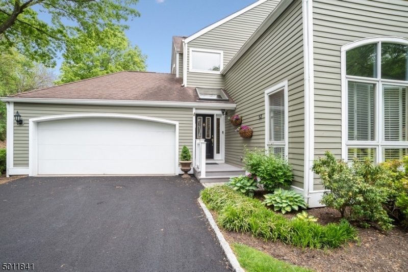 Absolutely pristine end unit with 1st floor master suite & 2 car garage in desirable Woodside section of Morris Township!  Freshly painted, new carpet!  Beautiful LR with cathedral ceiling, DR,  new kitchen open to family room with fireplace and sliders to gorgeous private, patio & private garden, 1st-floor master with luxury bath & walk-in closet and powder room.  Second floor features 2 bedrooms with jack 'n jill bath, loft used as an office & storage room.  Lower level offers a rec room, office, full bath, laundry, storage & utility room.  The large private patio has a gas line for a grill, beautiful landscaping and backs to woods.  Walk to town, restaurants, close to NYC train, shopping, transportation and more!