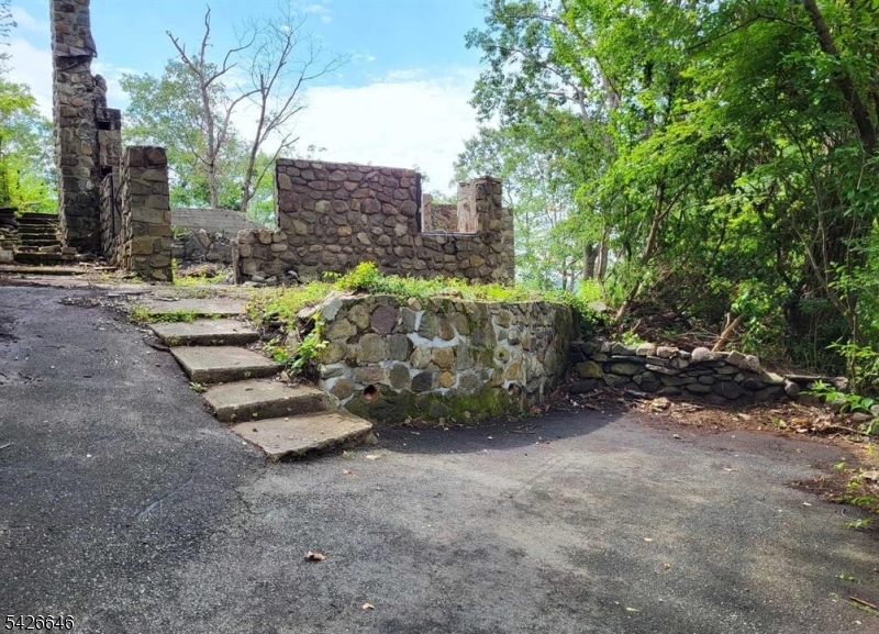 Imagine having a new home with breathtaking views!!! This is it! The original house burned down on 3.18.23 from the neighbour burning the leaves. Foundation and what was left of the first floor are still there including the chimney. 500 gal septic and well are on the property. Beautiful location just minutes from the NY border, and all activities on the lake.