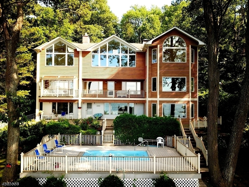 PRIME LOCATION! ONE OF A KIND, 3 LEVEL, UNIQUE, CUSTOM LAKEFRONT HOME BOASTS GORGEOUS VIEWS FEATURING IN-LAW SUITE, ELEVATOR, INDOOR & OUTDOOR POOLS, 5 BDRMS, 7.5 BATHS, LAUNDRY ON EVERY LEVEL, 2 MASTER BEDROOM SUITES, PRIVATE BALCONIES OFF TWO BEDROOMS, 2 COMPLETE KITCHENS WITH CORIAN COUNTERTOPS, NEW DISHWASHER AND STOVE. 2 FIREPLACES, WHOLE HOUSE GENERATOR, WOOD FLOORS, SKYLIGHTS, OVERSIZED & PARTIALLY FINISHED GARAGE HAS PLENTY OF STORAGE AND HALF BATH. FIRST FLOOR LEADS TO  PAVER PATIO OVERLOOKING POOL &  BOAT DOCK WITH NEW PYLONS & OF COURSE, PANORAMIC LAKE VIEWS - ~120' FT LAKEFRONT - DOUBLE LOT- CONVENIENTLY LOCATED MINS TO RTS 80, 46, 10 & NYC BUS & TRAINS. DON'T MISS THIS ONE! A MUST SEE!