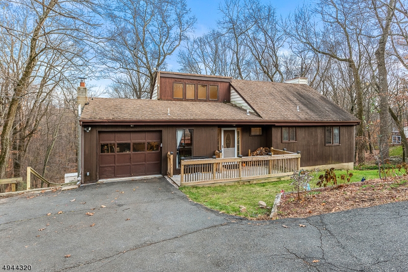 Great Opportunity in Randolph! Custom Raised Ranch w Reverse Floor Plan; 3 BRs, 2 1/2 Baths, Formal Dining and Living Rooms, Family Room w Fireplace, Optional 4th BR/Office, Tranquil Outdoor Space! This Unique Home was Architecturally Designed to Optimize it's Setting on a Private, Wooded 1 Acre Lot w Great Views. Offers HW Floors and Cathedral Ceilings on the First Floor, Eat-In Kitchen w New Stainless Appliances and Granite Counters. Huge 2 Tier Deck w Multiple Sliders on Both Levels providing Access and Light. Versitile Floor Plan 4th BR/Office. Here's Your Chance to Live in Fabulous Randolph Known for Excellent Commuting, Schools and Shopping. Low Taxes!