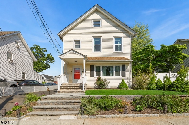 The opportunity you've been waiting for in Englewood! This beautifully updated Colonial welcomes you with wonderful curb appeal on a quiet block just minutes from downtown shopping, dining, and everyday conveniences. From the moment you enter, soaring ceilings and rich hardwood floors create a warm, inviting atmosphere filled with character and natural light. The kitchen is a true standout featuring a center island, granite countertops, ample cabinets, a water filtration system with an insta-hot dispenser (2025), newer refrigerator (2024), and an ideal layout for entertaining. A mudroom with extra storage and a full bathroom adds functionality to the main level. Upstairs, you'll find 3 well-appointed bedrooms with excellent natural light and an additional full bathroom. The home features a full attic with insulated, finished walls, new pull-down stairs (2025), and architectural plans for a future permanent staircase conversion. The finished basement provides valuable bonus space perfect for a recreation room, home office, or gym, complete with another full bath. Additional highlights include a newer hot water heater (2022), central air, a Vivint security system, and a brand-new custom garage door to be installed. Enjoy a low-maintenance brick patio, plus a detached two-car garage and long driveway. Conveniently located near houses of worship, schools, parks, Englewood Hospital, major highways, and the GWB for an easy Manhattan commute. Move-in ready and exceptional value!