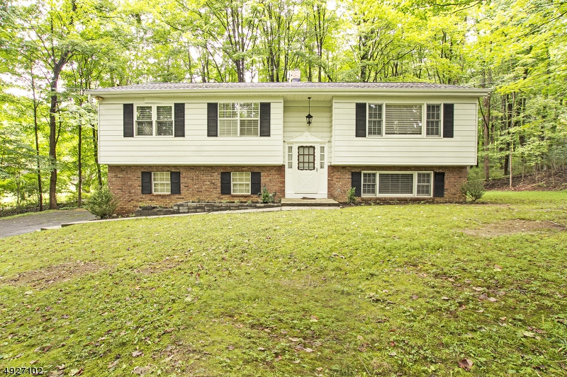 This meticulously maintained 4-bedroom 2.1 bath home has much to offer! The spacious floor plan includes gleaming hardwood flooring, formal dining room open to a large living room. The eat in kitchen has sliders to an entertainment size deck overlooking private wooded park like property. The lower level boasts a bedroom, bath and family room with woodburning stove with sliders out to the expansive patio. This home is conveniently located near major roadways, fine dining, shopping etc..