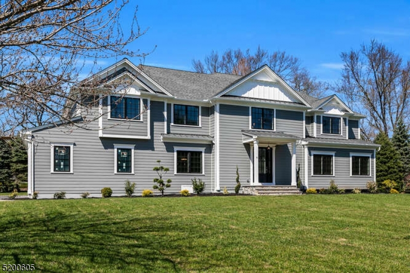 Magnificent fully renovated custom colonial situated on 1.06 acres! Meticulous attention to detail throughout, including 4" red oak flooring and custom moldings and millwork. Oversized windows fill the home with natural light. Grand two-story foyer leads to formal living room. Formal dining room with coffered ceiling and access to kitchen through the butler's pantry with wine refrigerator. Stunning kitchen with quartz countertops, GE Monogram stainless-steel appliances and custom white cabinetry extending to the ceiling. Additional highlights include the farmhouse sink, an enormous island with prep sink, seating, and storage, and breakfast area with double doors to rear patio. Adjacent family room with gas fireplace, coffered ceiling and double doors to yard. Completing the first floor are mud room, bedroom, and half bath. Primary bedroom boasts a double tray ceiling with crown molding, two custom fitted closets and private covered balcony. Luxurious primary bath has soaking tub and spa shower. 3 additional bedrooms and an en-suite and Jack and Jill bath both with quartz countertops and porcelain tile floors. An expansive bonus room with vaulted ceiling works well as an office space or media room. Finished lower level with rec room, bedroom and full bath. Outside features paver patio with built-in fire pit and expansive yard. Located in top NJ school district close to shopping, parks, restaurants, and transportation, this spectacular home will exceed your every expectation!