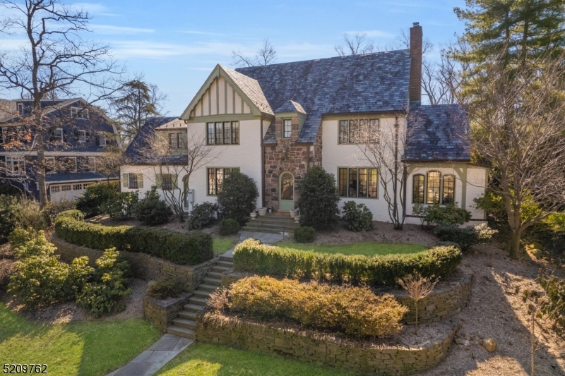 Spectacular 6, 4 Bath Bedroom Woodland Park Tudor situated on over .56 acre of level back yard.  Renovated throughout, this home is not to be missed.  Gourmet kitchen with adjacent family room with gas fireplace. French Doors to outdoor bluestone patio with wood burning fireplace and sprawling back yard.  Back stairwell to guest room and bath. Third floor with office/ entertainment area, bedroom, full bath.  Lower level boasts a large recreation room with bar, game room, excercise room, wine cellar, laundry and storage room. Wonderful entertaining  home. Whole house generator. Chimney, fireplaces and flues being sold in "As Is" condition with no know defects.
