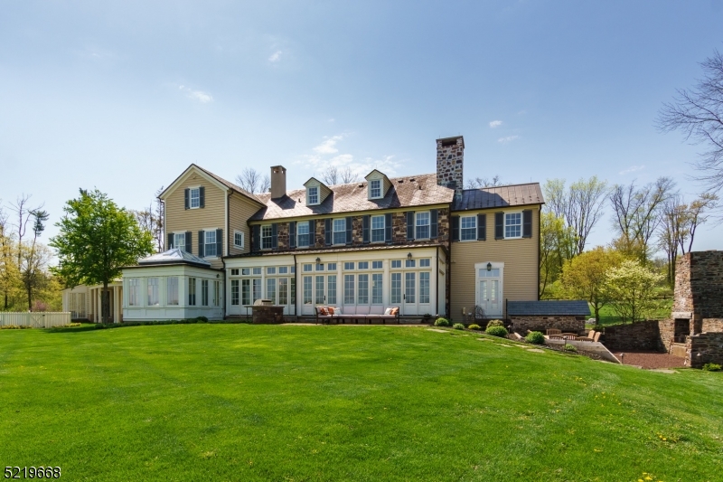 This spectacularly maintained home, farm and equestrian paradise offers 111 acres of versatile land with breathtaking views, providing a tranquil escape. The main house, built in 2010,  was designed to look like it has been a part of the landscape for over 100 years with a separate carriage house that serves well as a home office, studio, or guest house. The interiors are fitted with every modern amenity you'd expect in an offering of this caliber with a chef-designed kitchen, radiant-heated reclaimed wood floors, 7 bedrooms, a finished basement with wine cellar, gym, half bathroom, kitchenette, and media space, and so much more! Dine with guests in the glass-enclosed conservatory dining room with inspiring views of the pastures or take the party outside and relax by the outdoor fireplace. This self-sustaining estate features a tucked-away solar field, a commercial-grade organic greenhouse, a barn, a saltwater pool, and even a certified organic field! Equine facility features a 12-stall stable, indoor riding arena, caretaker's residence, and paddocks. All of this is within 4.2 miles of downtown Princeton and Princeton University!