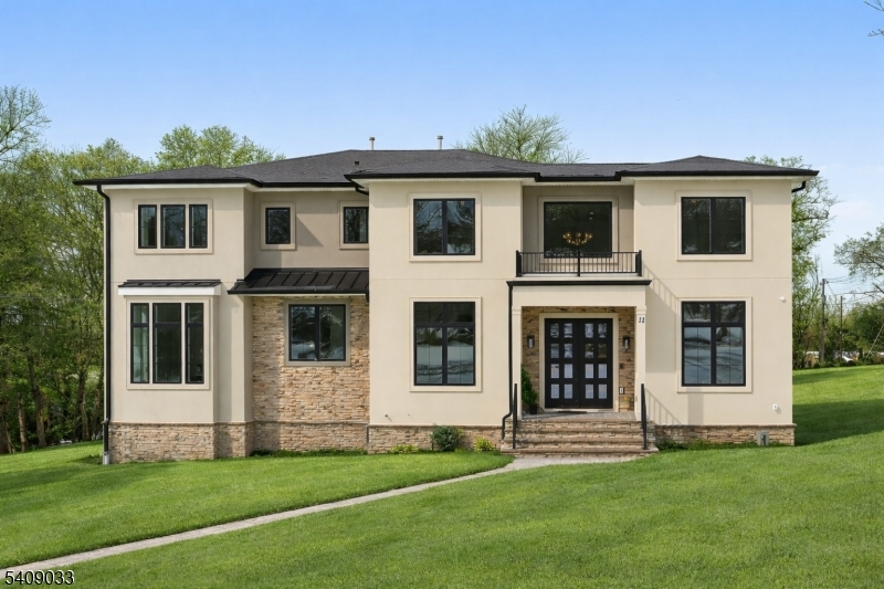 Modern Masterpiece with Timeless Curb Appeal. This exceptional NEW CONSTRUCTION Center Hall Colonial blends modern sophistication with classic architectural design in Livingstons prestigious Riker Hill section. Set on a flat 0.58-acre lot, this 5,700+ sq ft residence makes a striking first impression with its elegant stucco and stone facade. A grand two-story foyer with marble flooring introduces sun-filled interiors defined by clean lines, custom millwork, and refined finishes. The main level features formal living and dining rooms, a private office, custom mudroom, and a first-floor guest en-suite. The designer kitchen impresses with a waterfall quartz island, quartz backsplash, custom cabinetry, premium stainless steel appliances, walk-in pantry, and butler's pantry with wine cooler, flowing seamlessly into the dining area. The dramatic double-height family room with fireplace and built-in speakers opens to an expansive deck for effortless indoor-outdoor living. Upstairs, the primary suite offers two custom walk-in closets and a spa-like bath with soaking tub, dual vanities, and glass shower. Three additional en-suite bedrooms and laundry complete the level. The finished walk-out basement includes a recreation room, bar, fitness room, guest en-suite, and built-in speakers. A three-car EV-ready garage and a 10-year builder's warranty complete this feature-rich offering.