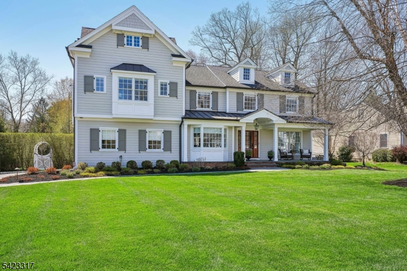THIS HAPPY, SUN-FILLED HOME IN CHATHAM'S COVETED WICKHAM WOODS OFFERS RESORT-LIKE LIVING WITH UNPARALLELED STYLE, CHARM AND ATTENTION TO DETAIL! Set on nearly 1/2 acre, this 5 bdrm/3.5 bath Colonial blends timeless elegance with modern updates and exceptional indoor-outdoor living.High ceilings, exquisite moldings, hardwood floors, sun-filled interiors and beautiful craftsmanship throughout. White gourmet kitchen features custom cabinetry, high-end appliances, a large island, and marble countertops/backsplash. The bar area flows seamlessly to the spacious family room with fireplace, large windows, and doors to the deck. Elegant living and dining rooms feature detailed millwork, gas fireplace and French doors open to a beautiful covered porch with wood-burning fireplace.Upstairs, the luxurious primary suite offers a tranquil retreat with spa-like bath with heated floors and walk-in closet. Four additional bdrms, custom lofts, en-suite baths, laundry, office/library and a bonus room with views provide wonderful space and flexibility.The backyard is truly exceptional, featuring a large heated pool, charming pool house, expansive deck, covered patio with fireplace, and beautifully curated gardens that create a private, resort-like and FUN oasis. Additional features include a welcoming front porch, landscape lighting, lower level rec area, wine room, two-car garage, sound system and generator. Close to Chatham's top-rated schools and NYC train/bus. MOVE IN AND ENJOY SUMMER!