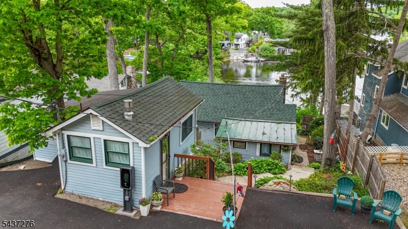 Lakefront Living at Its Best with Breathtaking Views of Cranberry Lake and a Rare Opportunity to own this totally updated and Stunning 2 Bedroom Lakefront Home with an impressive Guest Cottage (In-Law Suite). The sunset views help to enhance the elegant lifestyle offered by this unique home.You'll be totally impressed as you walk in the front door of the main house featuring a beautifully updated galley Kitchen, formal living room with dinette, large master bedroom, and a second bedroom with large picture windows with amazing lake views, office space, laundry room, and hardwood flooring throughout. Large entertaining deck overlooking the lake and dock space in a sheltered location in one of the nicest locations for your boat (No Wake Zone protected by the island). Walkout basement for storage. Guest cottage has been totally updated and offers a beautiful living room, bedroom with built-in bunk beds, and a full bath. The photos do not do this magnificent lakefront home justice - you truly need to see it to appreciate everything it has to offer. Don't miss the chance to make this lakefront beauty your own! Home can be sold furnished. Tesla charging station included. For the discriminating purchaser who can appreciate exquisite detailing and design, this home is worlds apart from other homes available in the marketplace. No other property more adequately describes the phrase, "When only the best will do" Cranberry Lake Membership is optional and offers lots of activities.
