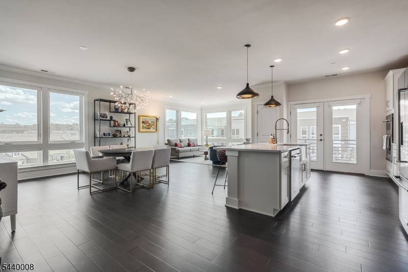 Highly sought-after and premier top floor corner unit, representing the pinnacle of one- floor luxury living. As the largest one floor model in the community, this exceptional residence is bathed in natural light and showcases designer finishes throughout.The open floor plan is anchored by a stunning kitchen that flows effortlessly into the living and dining spaces, creating an atmosphere that is sophisticated and inviting. Offering two bedrooms, two full baths and a versatile library with French doors ideal for a home office. The primary en suite features a spa inspired bathroom, generous storage and custom walk-in closet. Enjoy the convenience of maintenance free living along with private outdoor patio for relaxing or dining. Set within one of the areas highly regarded adult active communities known for its amenities, active lifestyle, residents enjoy access to club house, fitness center, indoor and outdoor pools, pickleball, tennis courts, bocce and a vibrant social calendar. Close proximity to downtown shopping, all major highways and Midtown direct train.