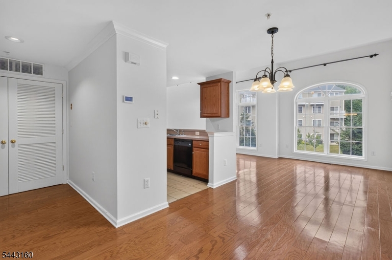 Move right into this beautifully maintained 2-bedroom, 2.5-bath townhouse with a spacious loft in the highly sought-after Reserve at Scotch Plains. Freshly painted throughout with brand-new carpeting, this turnkey home is tucked away in one of the community's most desirable locations, backing to peaceful woods for exceptional privacy. A welcoming foyer provides access to the attached one-car garage, storage area, and coat closet. The open-concept main level features soaring cathedral ceilings, gleaming hardwood floors, oversized windows creating a bright and inviting living space. The kitchen offers custom cabinetry, recently updated appliances, including a 30" 5-burner gas convection range (Dec. 2024), brand-new microwave, and a breakfast bar.  Upstairs, the versatile loft is perfect for a home office or additional living space.  The spacious primary suite features a private balcony overlooking the woods, an oversized custom walk-in closet, and an en suite bath with dual vanities, soaking tub, and separate shower. A second bedroom, full bath, and laundry room with a washer/dryer (2024) complete the upper level. Fresh paint, a new brand water heater, and new carpeting make this home truly move-in ready. Enjoy an exceptional location just minutes from Routes 22 and I-78, the NYC express bus, premier shopping and dining in Scotch Plains, and the top-rated Scotch Plains"Fanwood School District.
